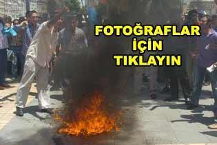 Protesto sırasında yaktığı bayrak yakıyordu..