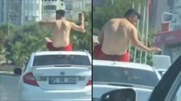 Otomobilin tavanında tehlikeli yolculuk 