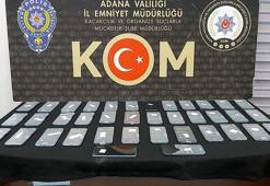 Kaçak telefonları, otobüs bagajındaki peynir tenekesine gizlemişler