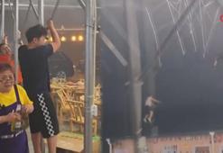 Çin’de şiddetli rüzgar tenteye tutunan insanları uçurdu