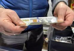 Sahte dolarla alışveriş yapıp bir de para üstü aldı