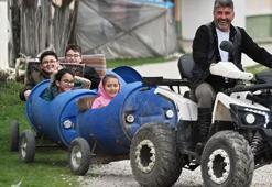 Köydeki çocuklar muhtarın yaptığı "bidon tren" ile eğleniyor